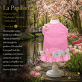 Pink pet dress, La Papillon in a garden setting with cherry blossoms, tulips, and a pond. Ruffled hem & butterfly appliqués.