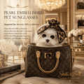 White Maltese in Louis Vuitton bag wearing pearl embellished round sunglasses and leopard scarf Beverly Hills mansion