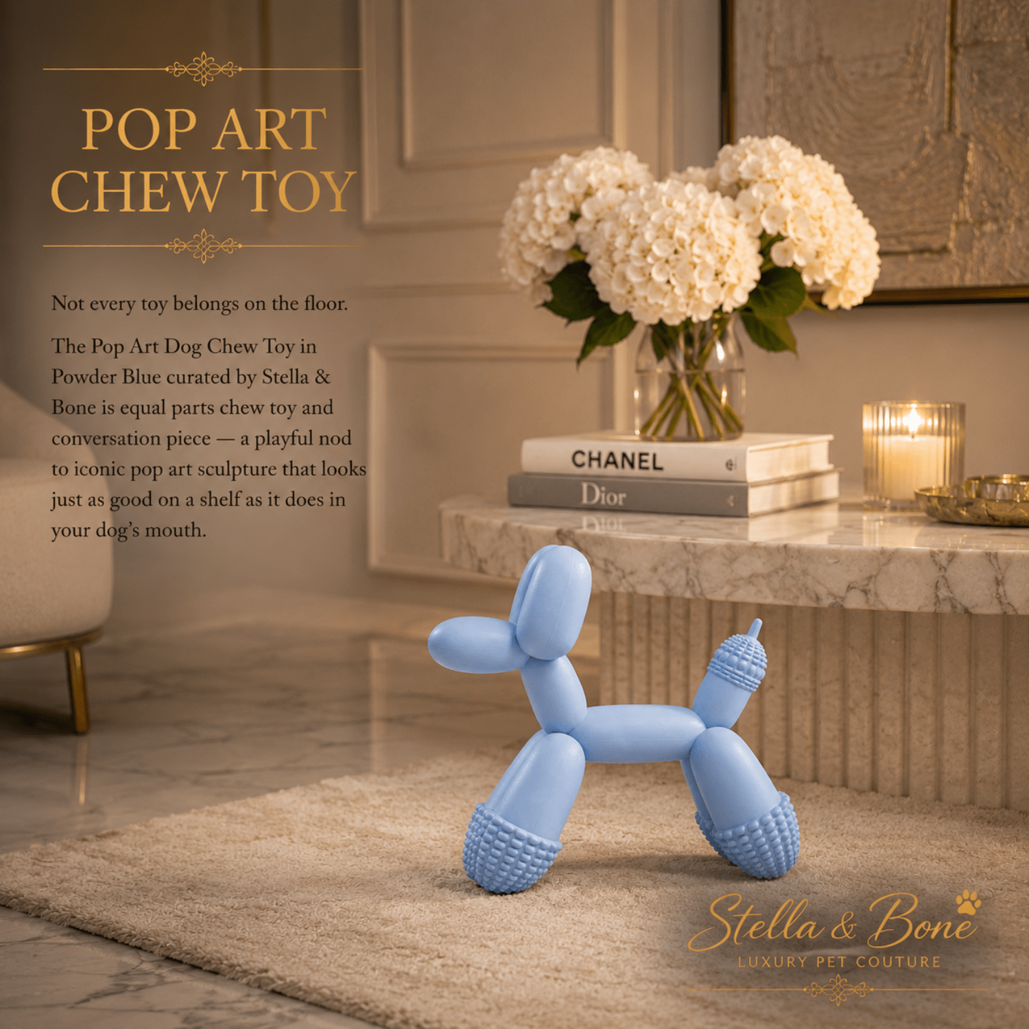 Pop Art powder blue balloon dog chew toy on cream rug beside Chanel Dior books luxury home decor dog toy