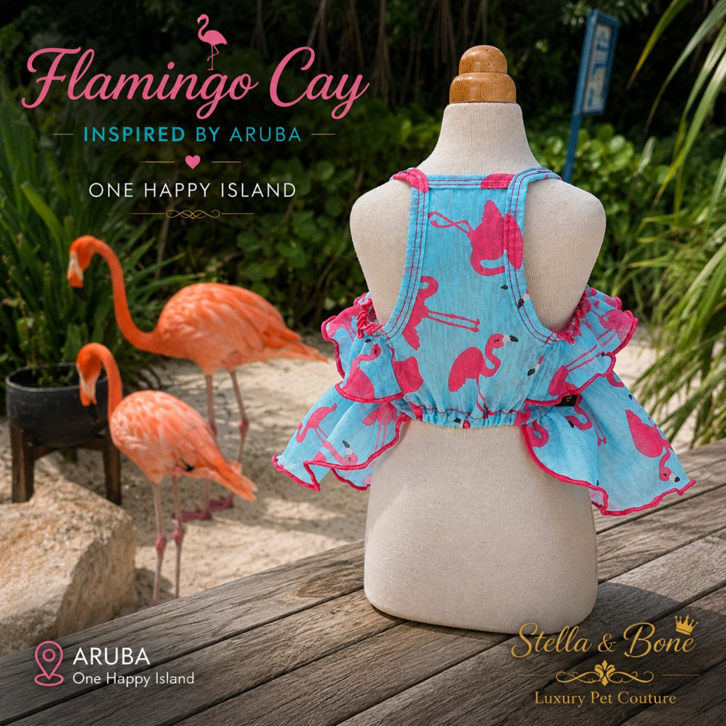 Back view of Flamingo Cay ruffled dog dress on mannequin with bright pink flamingos and tropical greenery behind.
