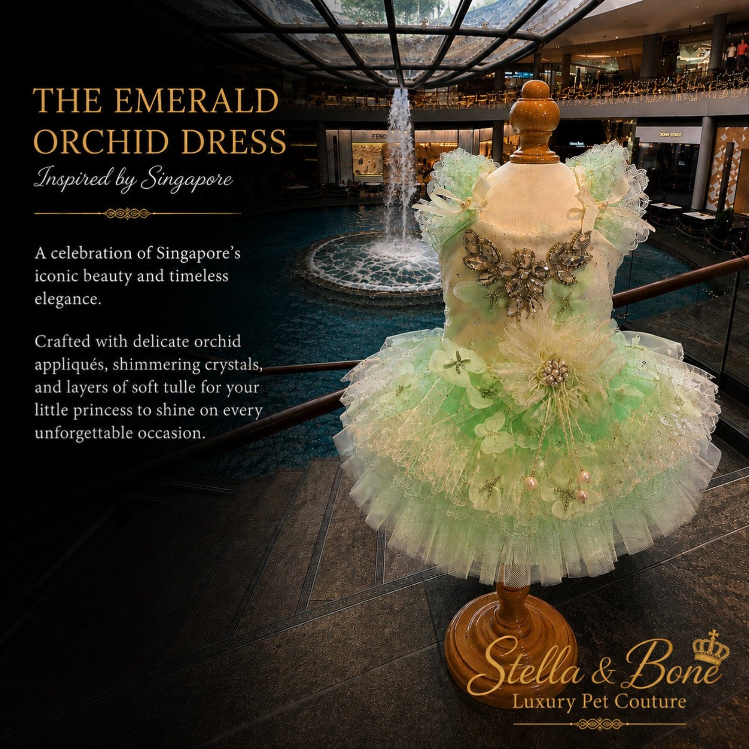 The Emerald Orchid couture dog wedding dress in mint green tulle on a mannequin with a luxury indoor waterfall backdrop.